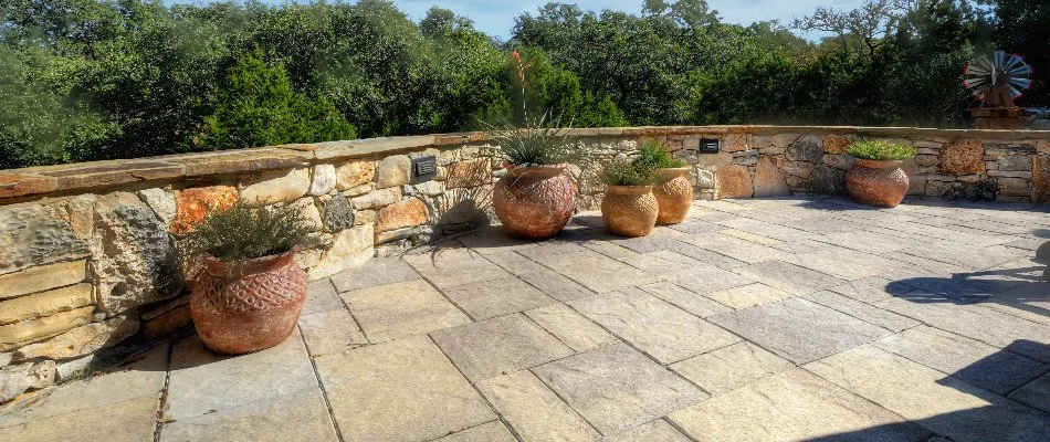 Paver patio and retaining wall with potted plants in Spring Branch, TX.