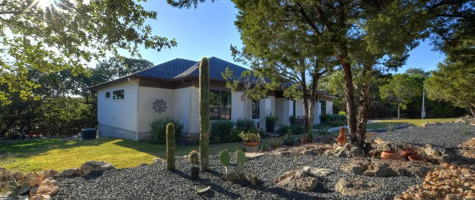 Rock landscaping in Bulverde, TX, with trees and other plants.