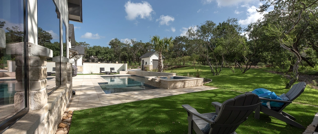 Artificial turf with a shrub in New Braunfels, TX.