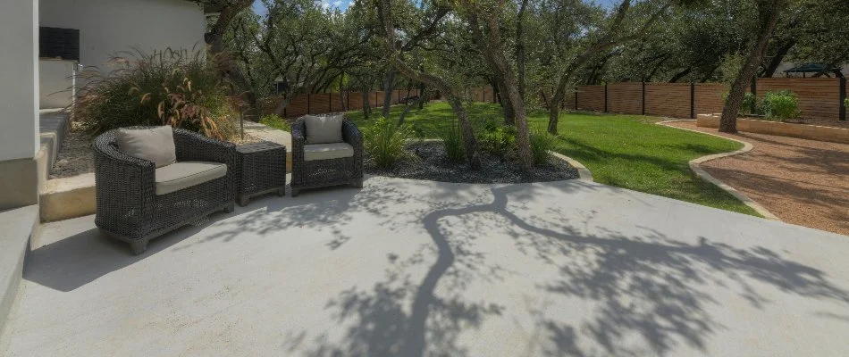 Concrete walkway, grass, and shrubs in New Braunfels, TX.