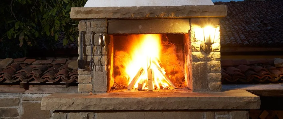 Gas outdoor fireplace in New Braunfels, TX, and outdoor lighting.