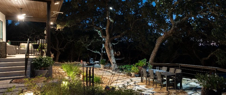 House and outdoor living space in New Braunfels, TX, with outdoor lighting.