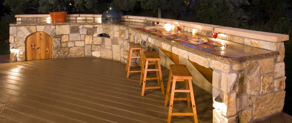 Outdoor kitchen in New Braunfels, TX, with bar and grill.