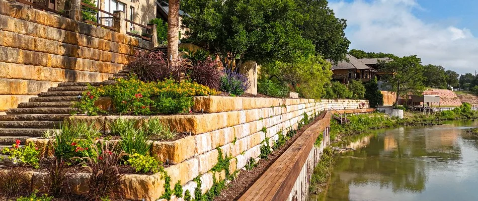 Retaining wall with nice landscaping near water in New Braunfels, TX.