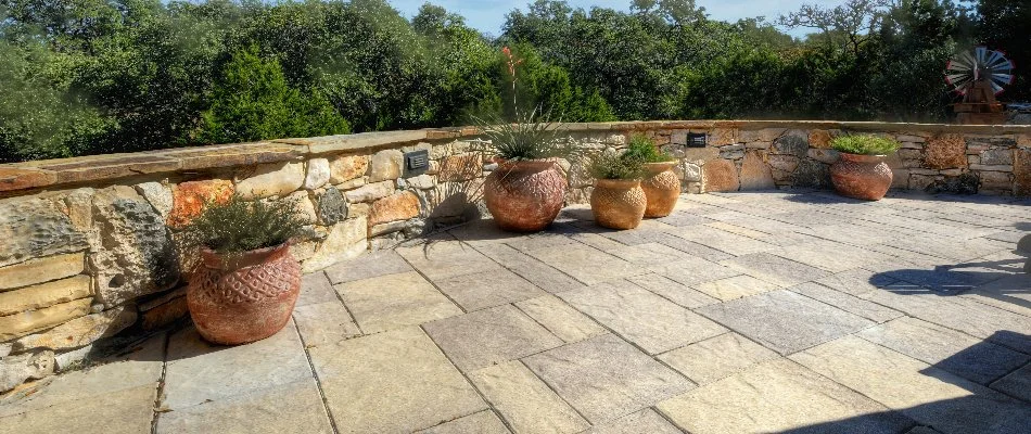 Patio in New Braunfels, TX, with a seating wall.