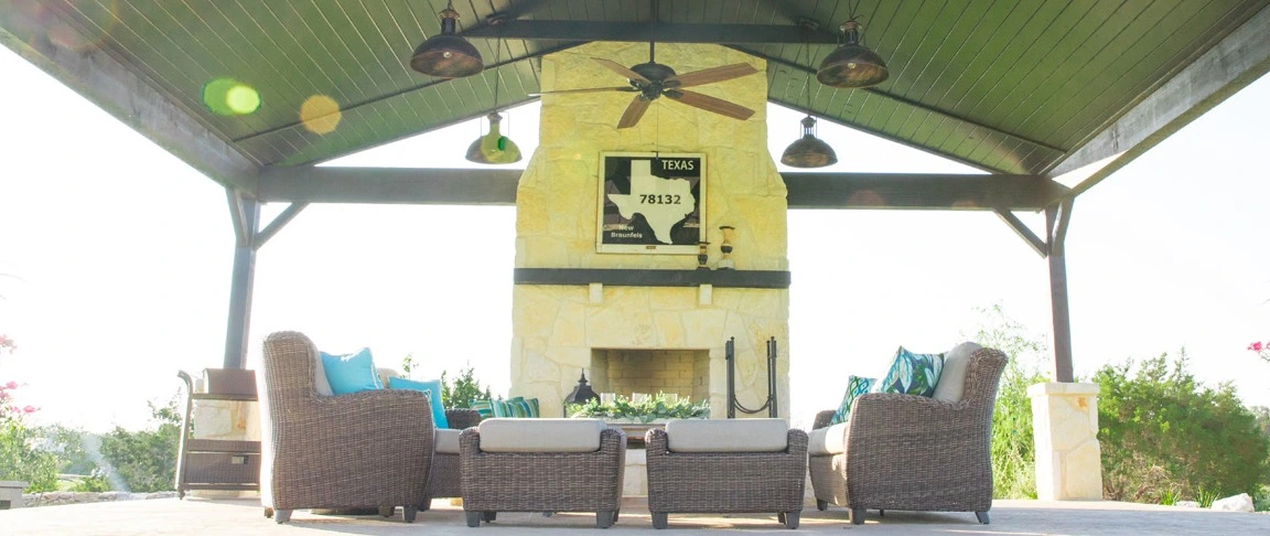 Gas outdoor fireplace in New Braunfels, TX, and outdoor lighting.