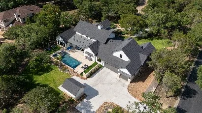 Backyard in New Braunfels, TX with healthy green grass.